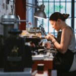 Female jeweller at work in jewellery workshop