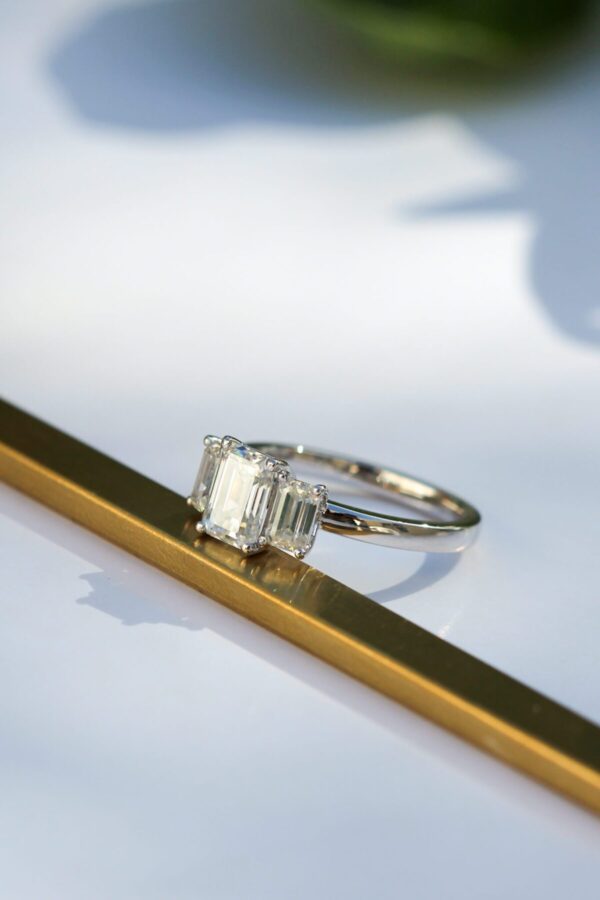 1ct Emerald Cut Moissanite Trilogy Ring in Platinum - Image 4