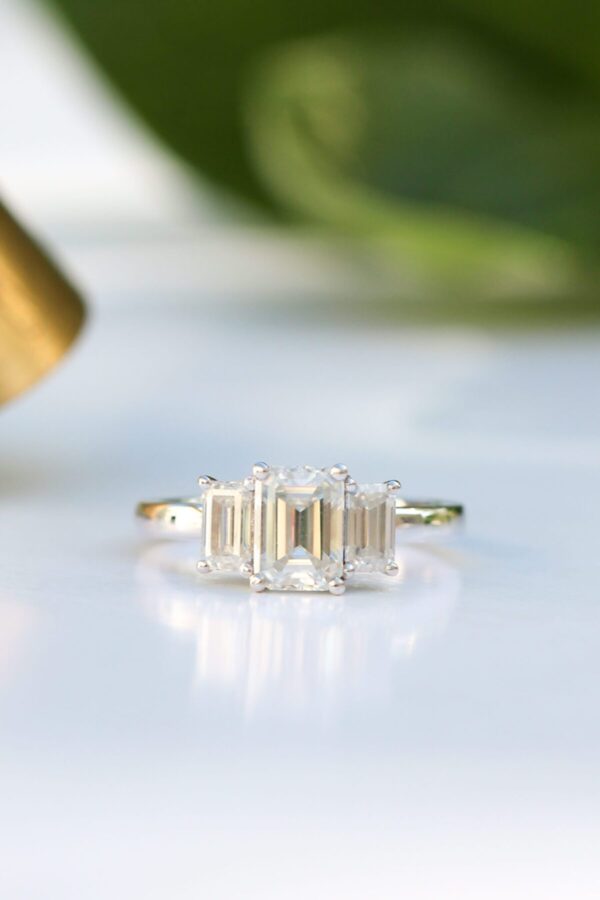 1ct Emerald Cut Moissanite Trilogy Ring in Platinum - Image 3